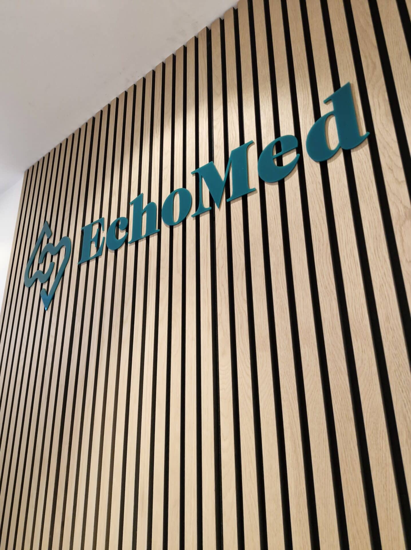 An upward view of the EchoMed logo on a wall.